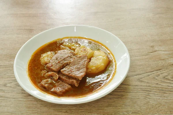 beef curry or Mussamun Indian food with slice potato on plate