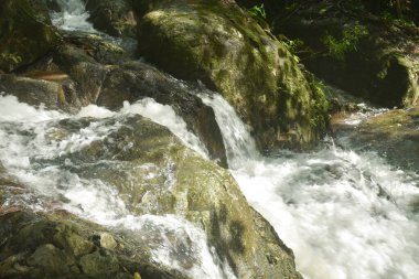 Su, Tayland 'ın kuzeyinde Chet Kod şelalesinde nehir geçidine taş ve kaya döküyor. 