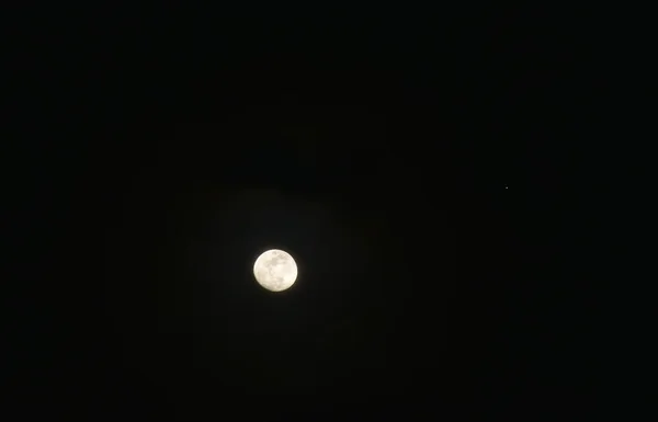 bright moon floating on sky in night background