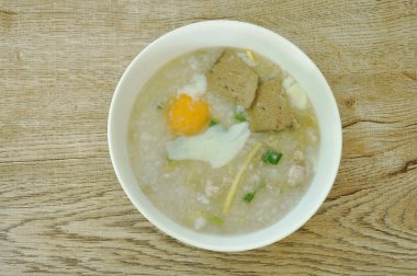 Pirinç lapası, domuz püresi, taze soğan ve maydanozlu yumurta sarısı. 