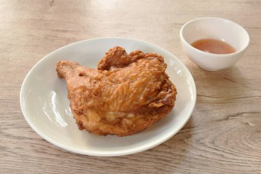 crispy fried chicken tight and leg on plate dipping sweet chili sauce cup 