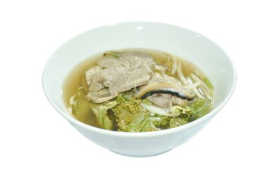 Kaynamış domuz eti ve fasulye filizi. Kabın üstünde siyah otlu lahana çorbası.