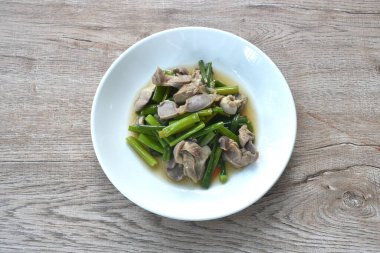 stir fried garlic chives with chicken organ on plate clipart