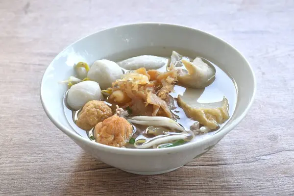 stock image boiled meatball made from fish and shrimp with dumpling topping jelly fish couple bean sprout in soup on bowl  