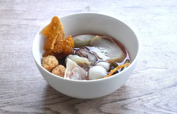 stock image boiled fish and shrimp ball couple dumpling topping pickled cuttlefish in red soybean sauce soup on bowl
