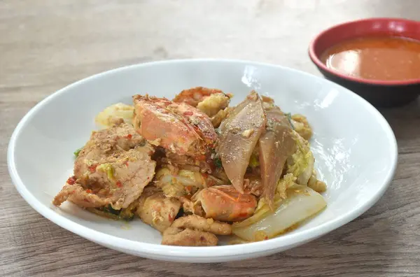 stock image fried glass noodles chicken and pork meat couple crispy pickled squid and shrimp with vegetable on plate dipping sukiyaki sauce