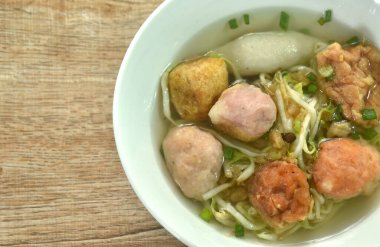 boiled Hakka meatball made from chop pork stuffing fried tofu with bean sprout and lettuce in soup on bowl clipart