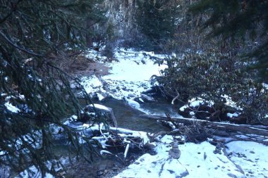 canal with snow at Four Girls Mountain or Siguniangshan as know as Switzerland travel location of China with sky background clipart