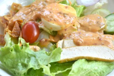 Haşlanmış yumurta, çıtır çıtır taro soslu Hint soslu salata. 