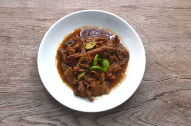 Baharatlı kızarmış domuz eti, kokuşmuş fasulye ve karides ezmesi soslu kırmızı biber. 