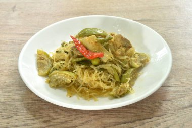 Karışık baharatlı, sebzeli, baharatlı cam şehriye ve tabakta Tayland usulü köri tozu ile domuz göbeği karıştır.