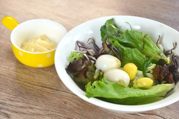 Kaynamış bıldırcın yumurtası, sebze salatası ve mayonez sosu sosu.