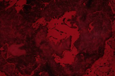 Spilled red paint on a thinner solution forming an abstract pattern. Selective focus on black background.