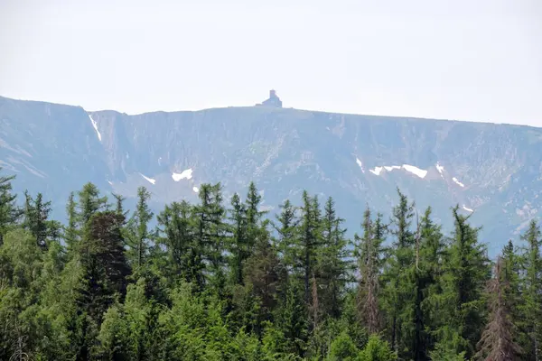 stock image A view of a forest and mountains, a radio and television tower at the top of the abski Szczyt, the Karkonosze National Park, Poland