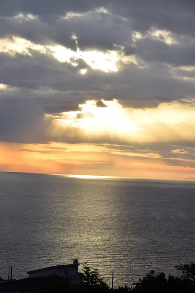 stock image Sunset above the open sea, with cloudy sky