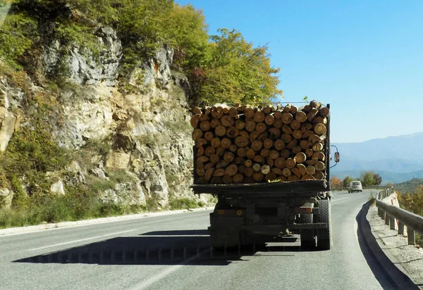 transporting wood by truck on a local road