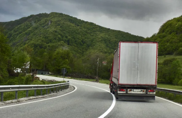 Heavy trucks on a mountain road