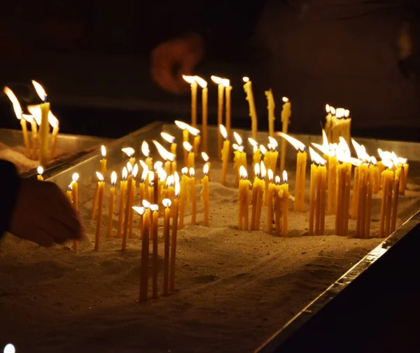 人们在教堂里点蜡烛 — 图库照片