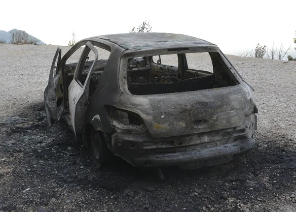 Burned car on the parking place by the road, after the car crash