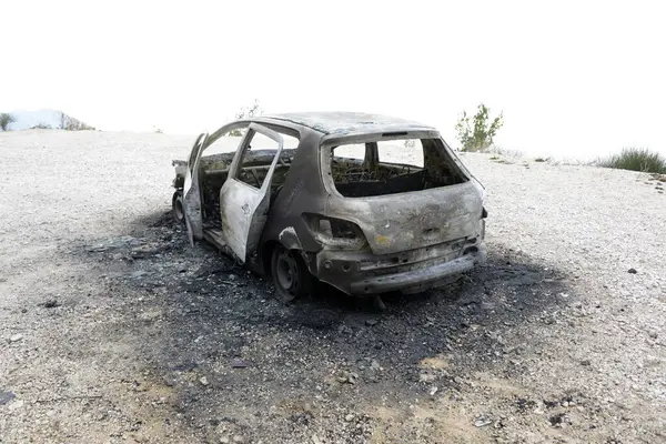 Burned car on the parking place by the road, after the car crash