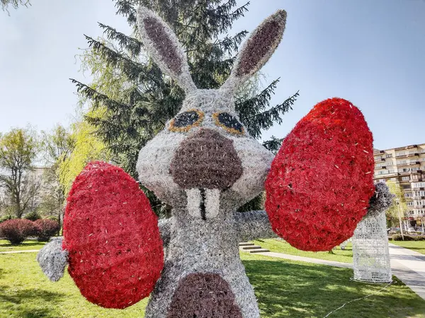 stock image A decorative rabbit holding two Easter eggs in Baia Mare city