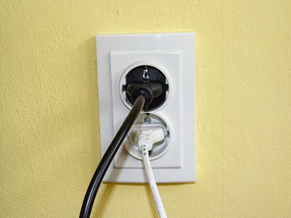 A black plug and a white plug in the socket