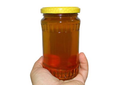 Bir elinde bir kavanoz poliflora balı