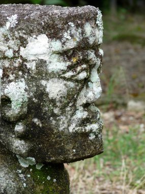 Close up of stunning, stone Batak face with blurred background, Lake Toba, Sumatra, Indonesia. High quality photo clipart