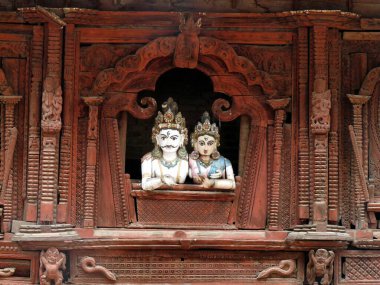 Intricately carved temple detail with Hindu man and woman,Patan, Nepal. High quality photo clipart