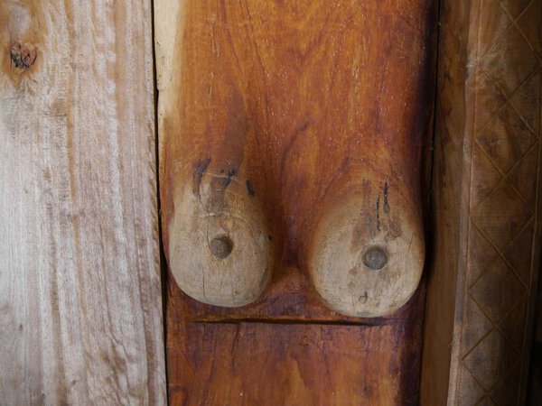  Natural looking brown, hand carved wooden breasts made by local wood carver in traditional village, Flores Island , Indonesia. High quality photo