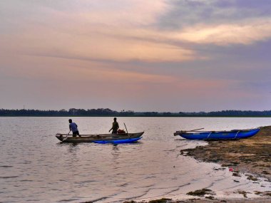 Men in boats on lake at sunset, Tissamarahama, Sri lanka. High quality photo clipart