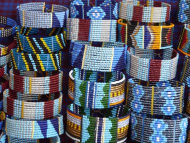 Close up display of colourful handmade Masai bracelets on sale, Kenya. High quality photo clipart