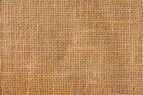 Texture of linen fabric in natural yellow color. The surface of the linen fabric as a background or banner, close-up
