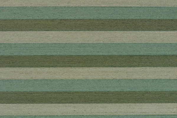 Striped green wood texture. Wooden shield glued from different types of wood in natural green color, top view.