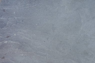 Texture of natural stone. Natural stone surface for flooring or wall decoration. Samples of gray stone with a wavy pattern for the interior.