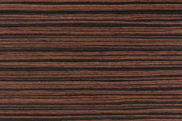 Macassar wood texture. High quality red and brown macassar wood plank surface texture. The texture of hard and heavy wood, with a beautiful surface for the production of furniture or flooring.