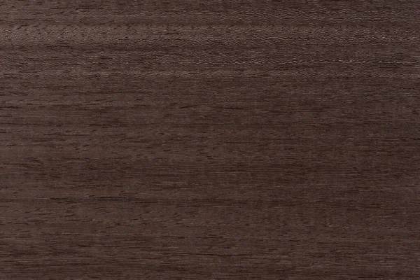 Texture of mahogany. Texture of koto wood with a reddish brown tint. Exotic rare wood from Africa for the production of expensive furniture or interior elements.