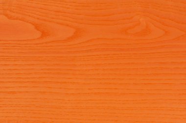 Orange wood texture. The large textured wood of the ash tree is painted orange. Orange ash