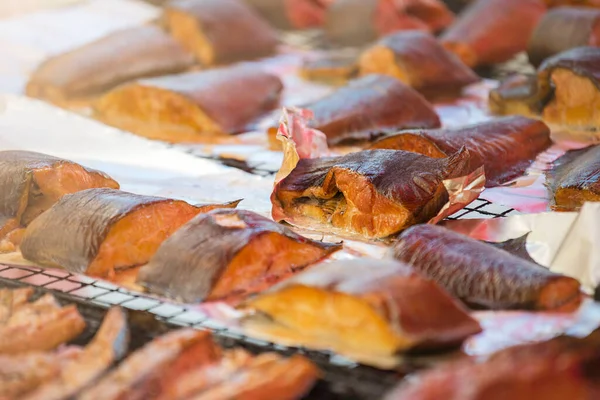 stock image Hot smoked salmon. Large pieces of Atlantic salmon are smoked on a smokehouse grate close-up. Fish smoking plant. High quality photo