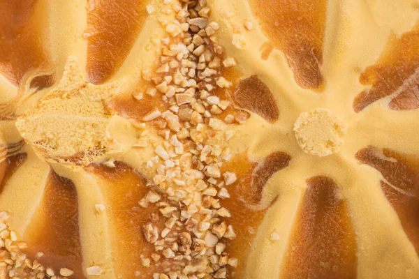 Texture of caramel ice cream. Ice cream with caramel crumbs and caramel icing. Fresh and tasty ice cream is a tasty treat for children and adults. High quality photo