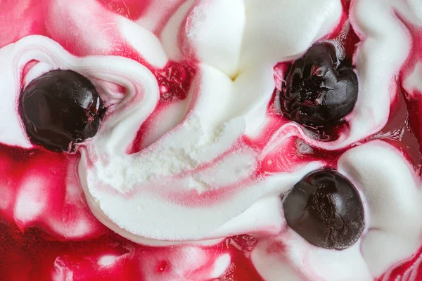 Texture of cherry ice cream. Fresh and delicious ice cream with cherries is a tasty treat for children and adults. High quality photo