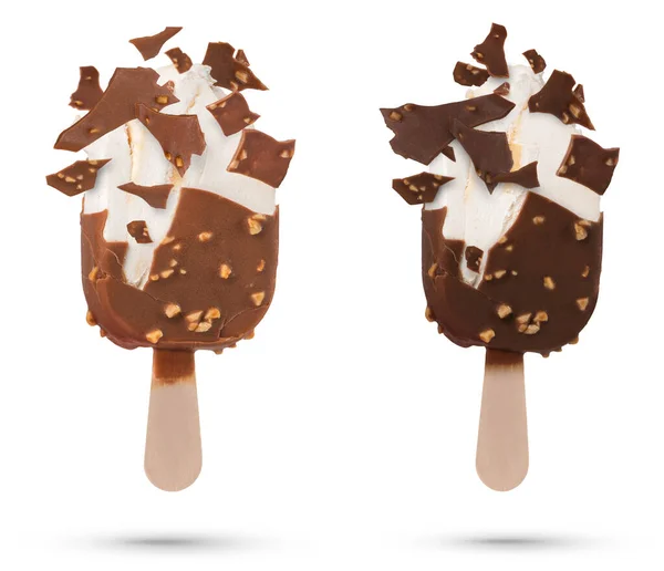 Chocolate ice cream isolate on a stick flying pieces of chocolate icing. Chocolate ice cream on a white isolated background with scattered pieces of chocolate and vanilla inside
