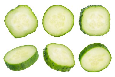 Beyaz izole edilmiş arka planda yeşil salatalık çemberleri. Salatalık dilimleri farklı yönlere dağılır. Salataya lezzetli bir ilave konsepti. Yüksek kalite fotoğraf