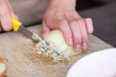 Kadın eli, soğanı parçalara ayırıyor. Et için baharat hazırlama süreci. Yüksek kalite fotoğraf