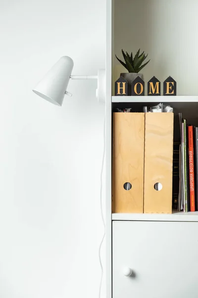 stock image White wall lamp on white wall background. Saving energy. Living during blackout concept. Copy space for a free text. Mockup for Scandinavian interior design project. Stylish book shelf design