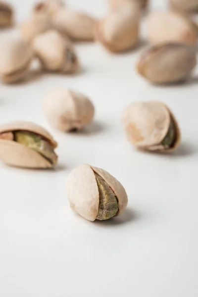 stock image Close up of pistachio nut seeds in shells isolated on the white background. Salted dried beer snack. Macro shot