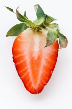 Top view of fresh red strawberries slice isolated on white background. Summer berries textured background. Flat lay. Macro shot of strawberry cut in a half