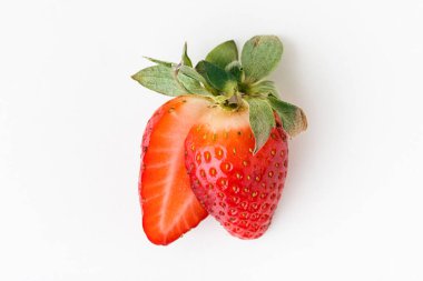 Top view of fresh red strawberries slice isolated on white background. Summer berries textured background. Flat lay. Macro shot of strawberry cut in a half