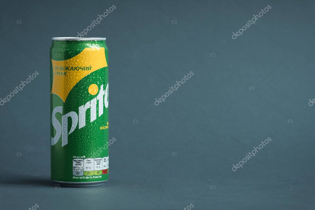 KYIV, UKRAINE - May 09: Close up shot of classic Sprite green can on the grey background. Popular product of The Coca-Cola company. Cold drink concept