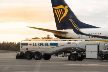 Luxembourg City, Luxembourg - April 27, 2024: Boeing aircraft of Ryanair airlines on tarmac next to fuel truck at Luxembourg airport. Big passenger airplane refueling and getting ready for departure clipart